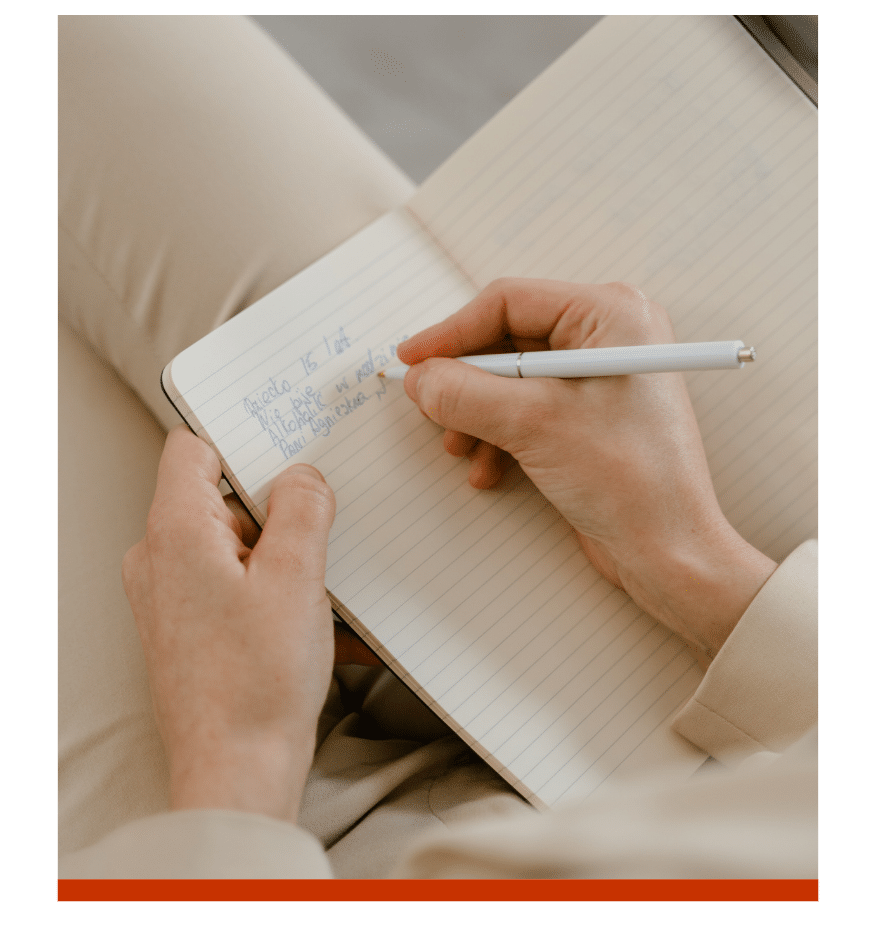 Handwriting in a journal with a white pen.