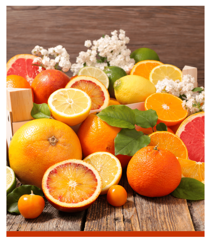 Assortment of colorful citrus fruits on a wooden table.