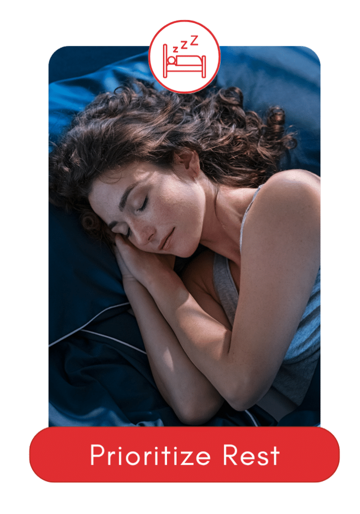 Peaceful woman sleeping on a navy bed with relaxed expression.