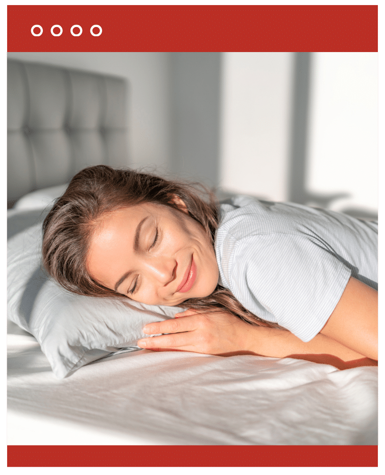 Woman sleeping peacefully on a bed with a smile, promoting good sleep hygiene.